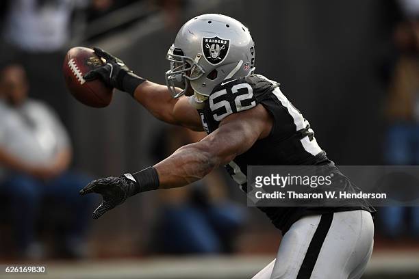Khalil Mack of the Oakland Raiders scores after intercepting Cam Newton of the Carolina Panthers in the second quarter of their NFL game on November...