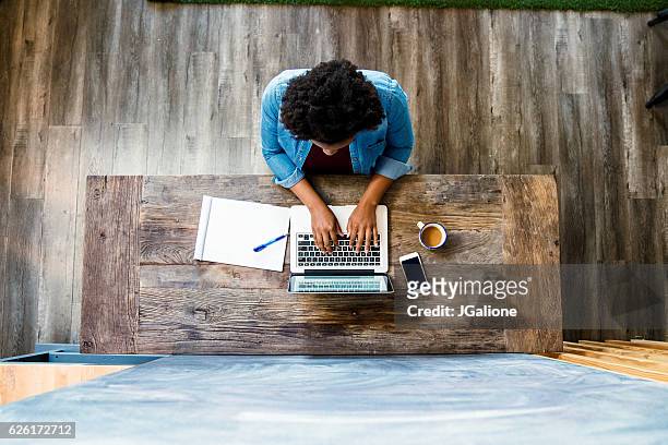 overhead view of a woman using a computer - overhead view stock pictures, royalty-free photos & images
