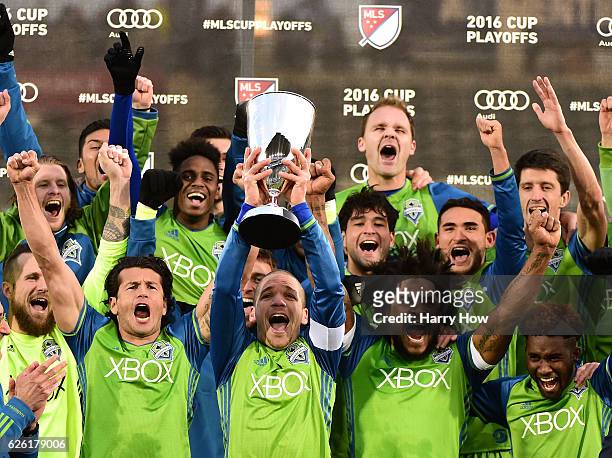 Osvaldo Alonso of Seattle Sounders holds up the MLS Western Conference Trophy after defeating the Colorado Rapids 1-0 at Dick's Sporting Goods Park...