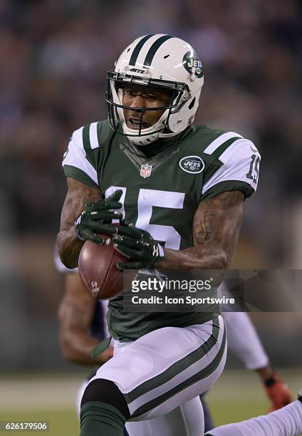New York Jets Wide Receiver Brandon Marshall maintains control of the pass during the NY Jets vs New England Patriots NFL football game on November...