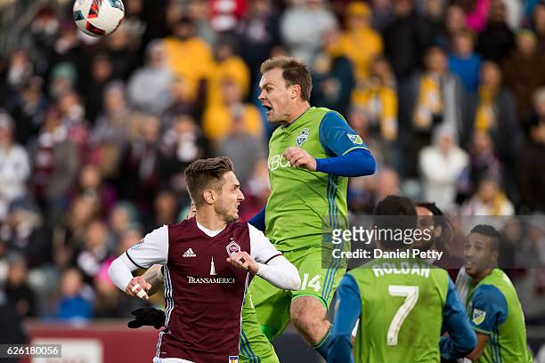 Chad Marshall of Seattle Sounders heads the ball away from Kevin Doyle of Colorado Rapids during the second half of the second leg of the Western...