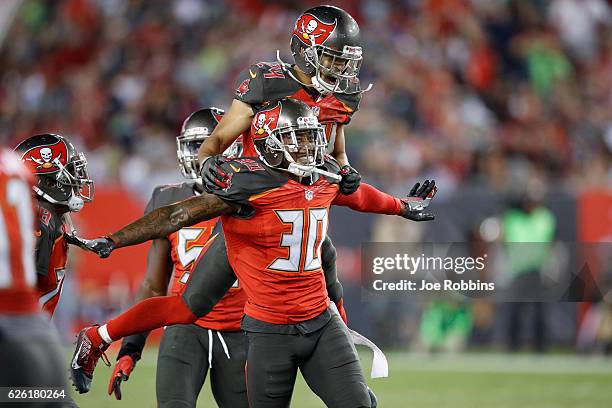 Bradley McDougald and Brent Grimes of the Tampa Bay Buccaneers celebrate after a fourth down stop against Seattle Seahawks in the fourth quarter of...