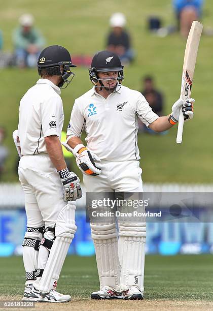 Kane Williamson with Tom Latham of New Zealand as he acknowledges scoring 50 runs during day four of the Second Test match between New Zealand and...