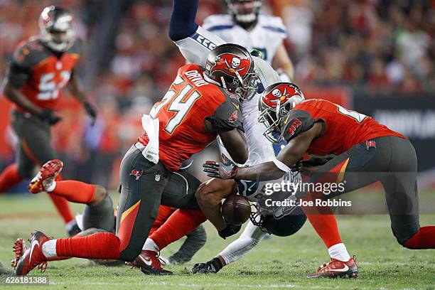 Jimmy Graham of the Seattle Seahawks fumbles the ball after being hit by Lavonte David of the Tampa Bay Buccaneers in the fourth quarter of the game...