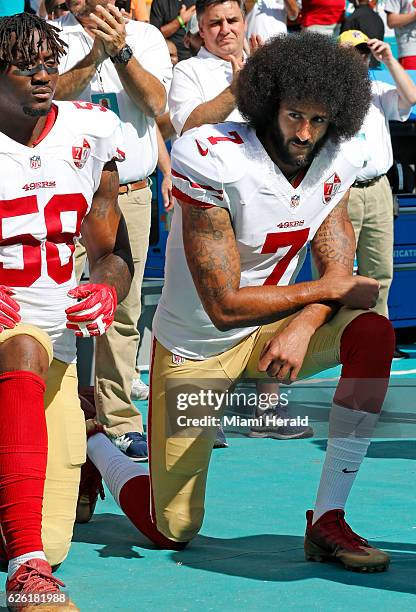 San Francisco 49ers outside linebacker Eli Harold and quarterback Colin Kaepernick take a knee during the national anthem before a game against the...