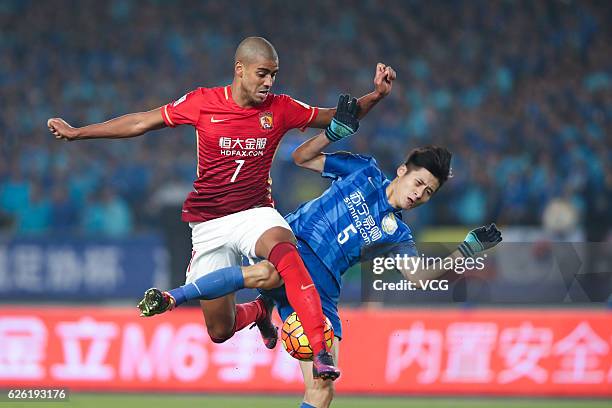 Alan Carvalho of Guangzhou Evergrande and Zhou Yun of Jiangsu Suning vie for the ball during the final second leg of Yanjing Beer 2016 Chinese...