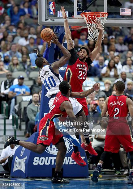 Harrison Barnes of the Dallas Mavericks drives to the basket against Solomon Hill of the New Orleans Pelicans; Anthony Davis of the New Orleans...