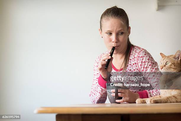 middle-aged woman vaping with her cat. - i quit stock pictures, royalty-free photos & images