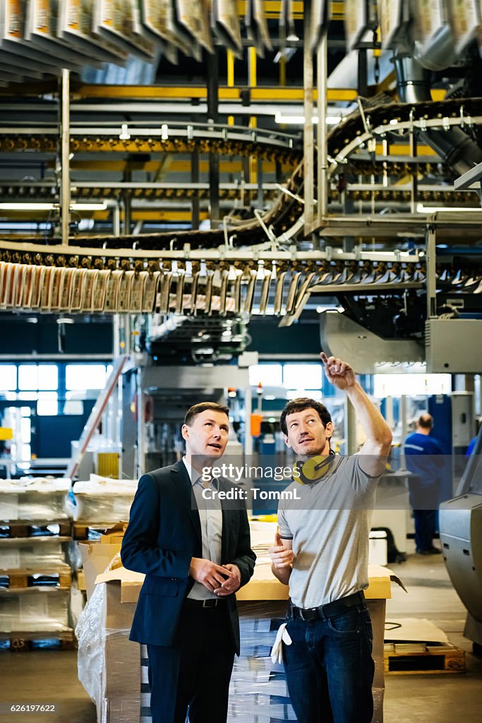 Mechanic and Manager talking in a printery