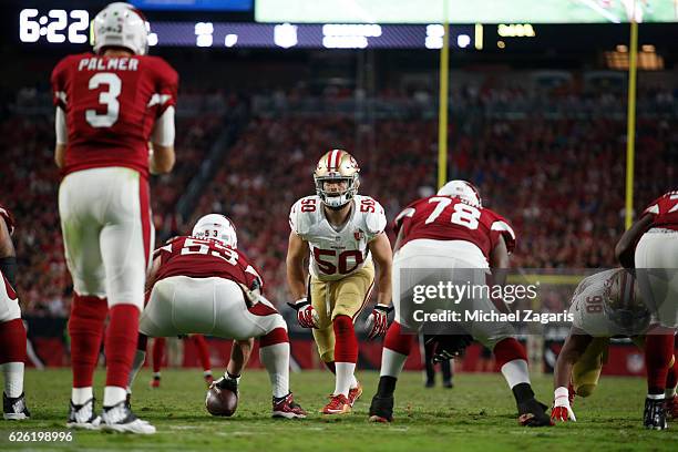 Nick Bellore of the San Francisco 49ers eyes the quarterback during the game against the Arizona Cardinals at the University of Phoenix Stadium on...