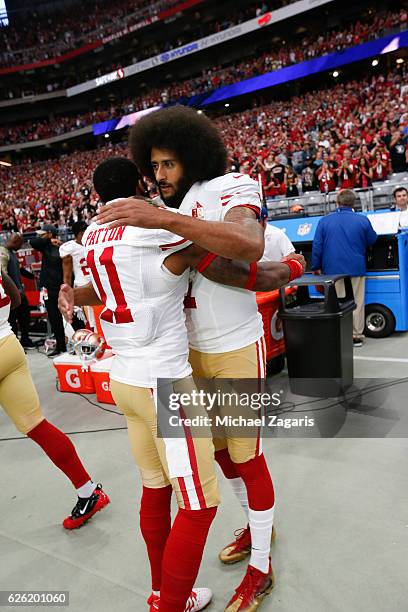 Quinton Patton and Colin Kaepernick of the San Francisco 49ers embrace on the sideline prior to the game against the Arizona Cardinals at the...