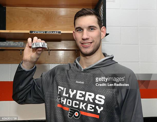 Anthony Stolarz of the Philadelphia Flyers poses with a puck celebrating his first NHL win, a 5-3 victory against the Calgary Flames on November 27,...
