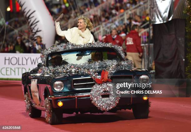 Olivia Newton John, grand marshall, waves during the 85th annual Hollywood Christmas Parade on Hollywood Boulevard in Hollywood, on November 27, 2016.