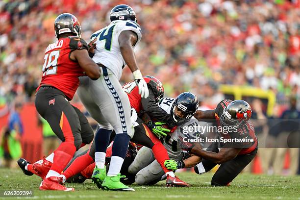 Seattle Seahawks Running Back Thomas Rawls is tackled by Tampa Bay Buccaneers Defensive End Robert Ayers during an NFL football game between the...