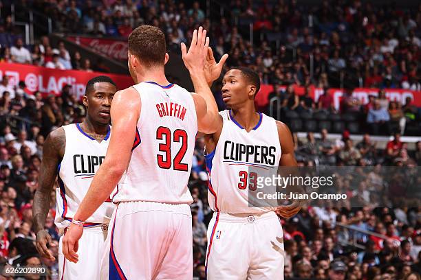 Wesley Johnson of the LA Clippers reacts with teammates Blake Griffin and Jamal Crawford during the game against the Portland Trail Blazers on...