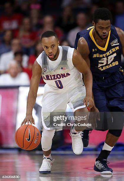 Parker Jackson-Cartwright of the Arizona Wildcats is defended by Jon'te Dotson of the Northern Colorado Bears during the first half of the NCAA...