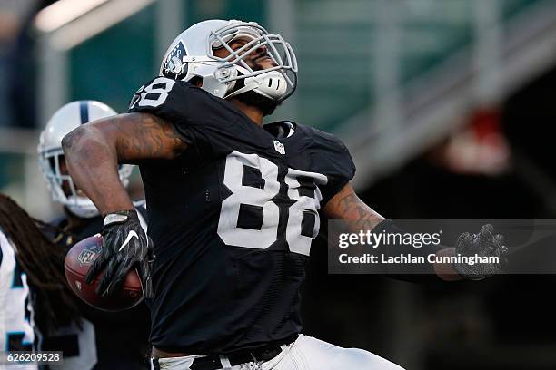 Clive Walford of the Oakland Raiders celebrates after a 12-yard touchdown against the Carolina Panthers during their NFL game on November 27, 2016 in...