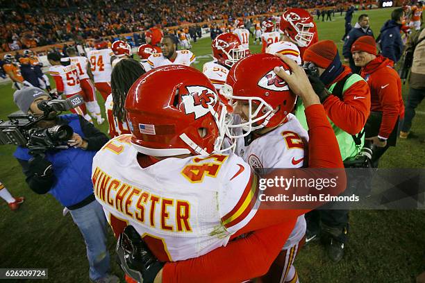 Long snapper James Winchester of the Kansas City Chiefs and Dustin Colquitt celebrate after kicker Cairo Santos made a game-winning field goal in...