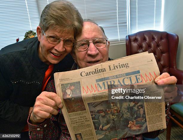 James and Louise Brock hold a copy of the Charlotte Observer from Nov. 29 showing a photo of his heart transplant operation. He's longest surviving...