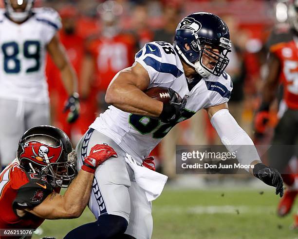 Tight end Jimmy Graham of the Seattle Seahawks is tackled by Safety Chris Conte of the Tampa Bay Buccaneers during the game at Raymond James Stadium...