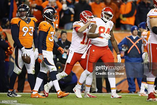 Quarterback Alex Smith of the Kansas City Chiefs celebrates with tight end Demetrius Harris after Harris caught a pass on a two-point conversion to...