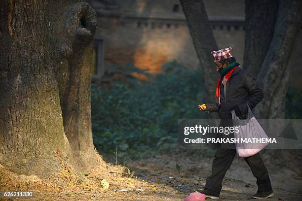 Nepalese Hindu devotee offers various plant seeds during the Balachaturdashi festival at the Pashupatinath temple in Kathmandu on November 28, 2016....