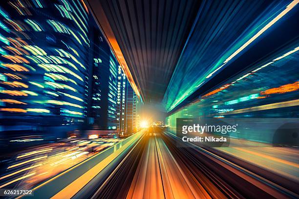abstract motion-blurred view from a moving train - abstract cityscape stockfoto's en -beelden