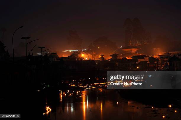 An illuminated view of Pashupatinath Temple along with the floating oil lamps at Bagmati river at the Pashupatinath Temple on the occasion of Bala...