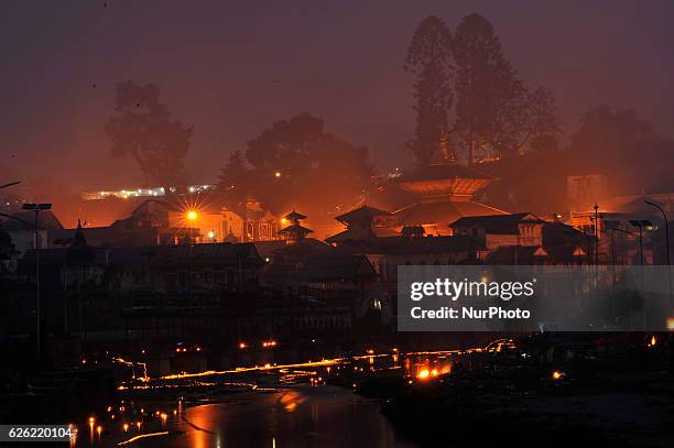 An illuminated view of Pashupatinath Temple along with the floating oil lamps at Bagmati river at the Pashupatinath Temple on the occasion of Bala...