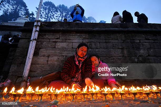 Nepalese devotees offering 108 butter lamps on the bank of Bagmati river on the occasion of Bala Chaturdashi festival celebrated in Kathmandu, Nepal...