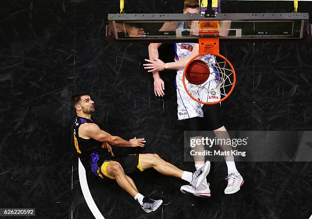 Kevin Lisch of the Kings is fouled by Matt Hodgson of the 36ers during the round eight NBL match between the Sydney Kings and the Adelaide 36ers at...