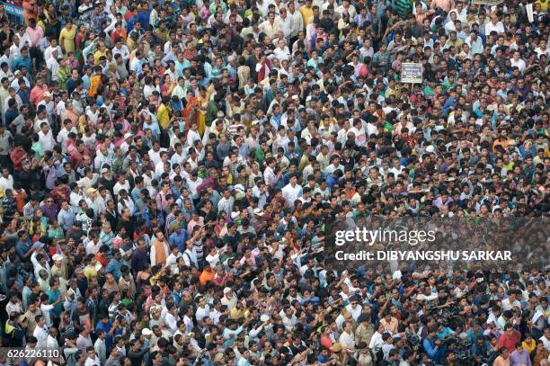 Indian activists from the Trinamool Congress political party listen as the Chief Minister of eastern state of West Bengal and TMC leader Mamata...