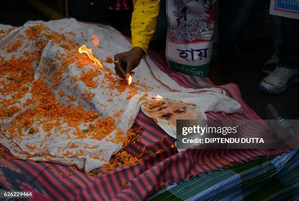 Indian members of the Congress Party burn an effigy of Prime Minister Narendra Modi during a protest against demonetisation in Siliguri on November...