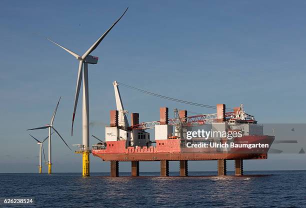 Wind turbines in the offshore wind farm Amrumbank West of the E.ON SE and the installation vessel for wind turbines MPI Resolution .