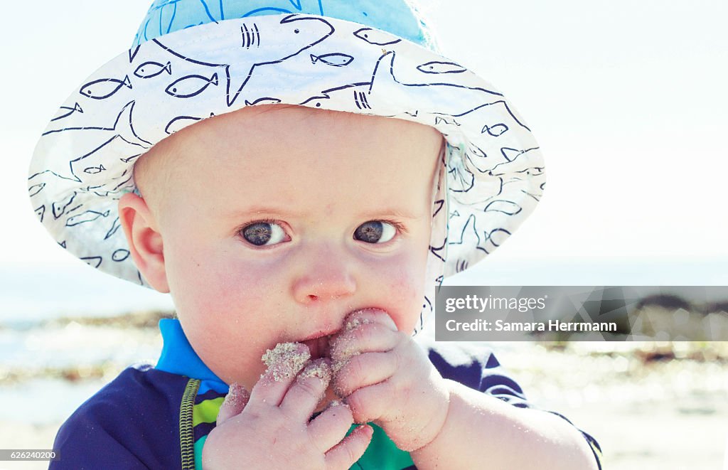 Baby with sandy mouth