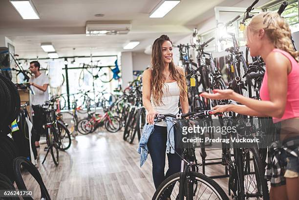 female customers in bicycle store - bike handle stock pictures, royalty-free photos & images