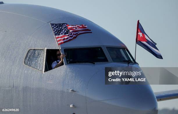 An American Airlines plane fluttering US and Cuba national flags is seen uppon arrival at Jose Marti International Airport becoming the first...