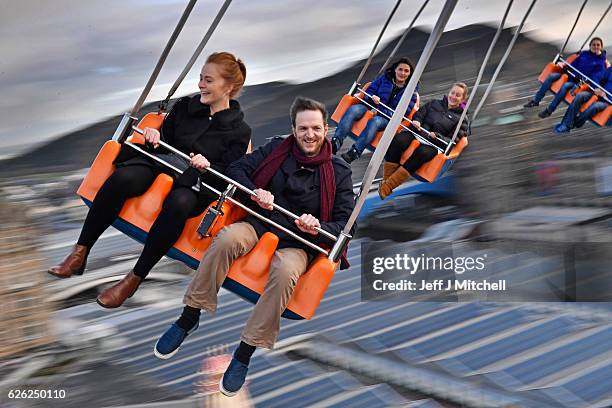 Members of the public enjoy a ride on the star flyer on November 28, 2016 in Edinburgh, Scotland. The star flyer is one of a number of rides situated...