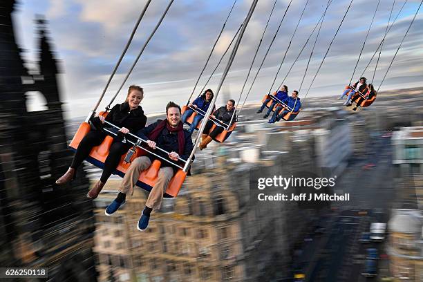 Members of the public enjoy a ride on the star flyer on November 28, 2016 in Edinburgh, Scotland. The star flyer is one of a number of rides situated...