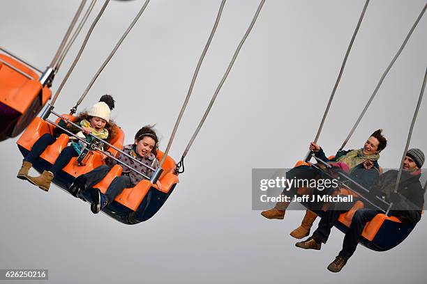 Members of the public enjoy a ride on the star flyer on November 28, 2016 in Edinburgh, Scotland. The star flyer is one of a number of rides situated...