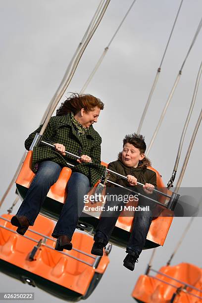 Members of the public enjoy a ride on the star flyer on November 28, 2016 in Edinburgh, Scotland. The star flyer is one of a number of rides situated...