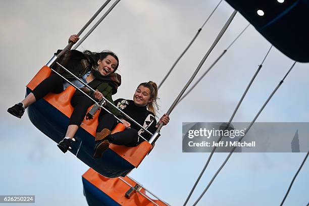 Members of the public enjoy a ride on the star flyer on November 28, 2016 in Edinburgh, Scotland. The star flyer is one of a number of rides situated...