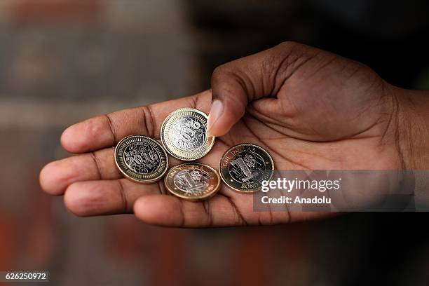 Man shows new coins as Zimbabwe Central bank launches new banknotes due to economical crisis in the country and decreasing of cash stores, in Harare,...