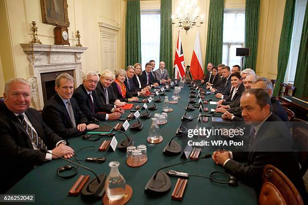 British Prime Minister Theresa May sits opposite her Polish counterpart Beata Szydlo, along with an intergovernmental consultation team from both...