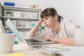 Disappointed woman working with a laptop