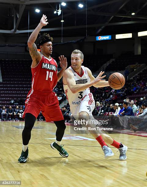 Singler of the Raptors 905 handles the ball against Damion Lee of the Maine Red Claws on November 26 at the Hershey Centre in Mississauga, Ontario,...