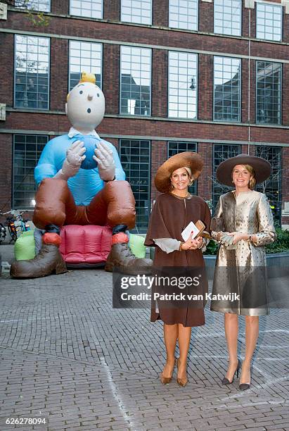 Queen Maxima of the Netherlands and Queen Mathilde of Belgium pose in front of Belgian figure Kuifje during their visit to the Flemish culture house...