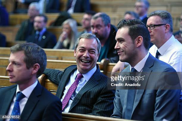 Former UKIP leader Nigel Farage sits with delegates after Paul Nuttall has been named as the new party leader on November 28, 2016 in London,...