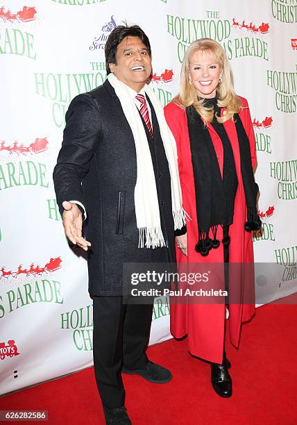 Actor Erik Estrada and Author Laura McKenzie attend the 85th Annual Hollywood Christmas Parade on November 27, 2016 in Hollywood, California.