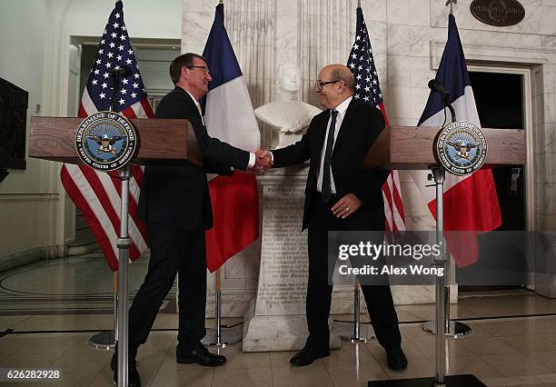 Secretary of Defense Ashton Carter and French Minister of Defense Jean-Yves Le Drian shake hands prior to their fourth meeting in the past five...